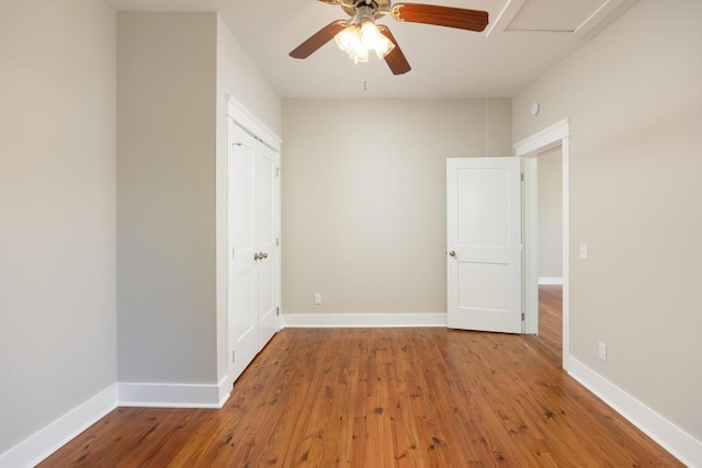 empty room with hardwood / wood-style flooring and ceiling fan