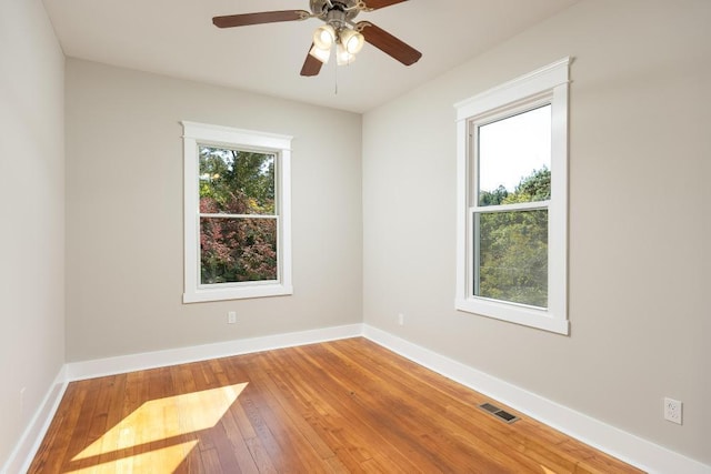 empty room with ceiling fan and hardwood / wood-style floors