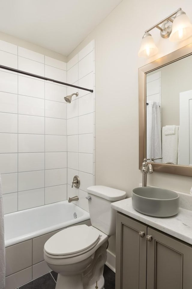 full bathroom with vanity, shower / tub combo with curtain, and toilet