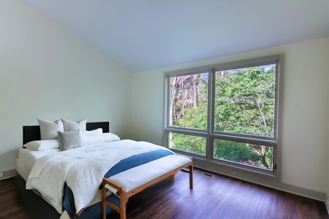 bedroom featuring lofted ceiling and dark hardwood / wood-style floors