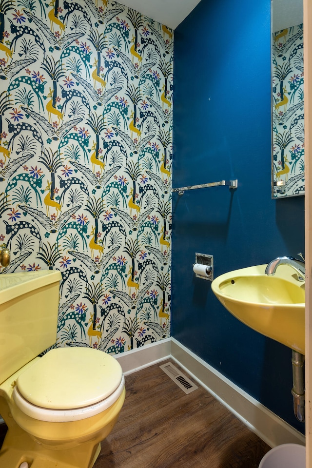 bathroom featuring toilet and hardwood / wood-style flooring