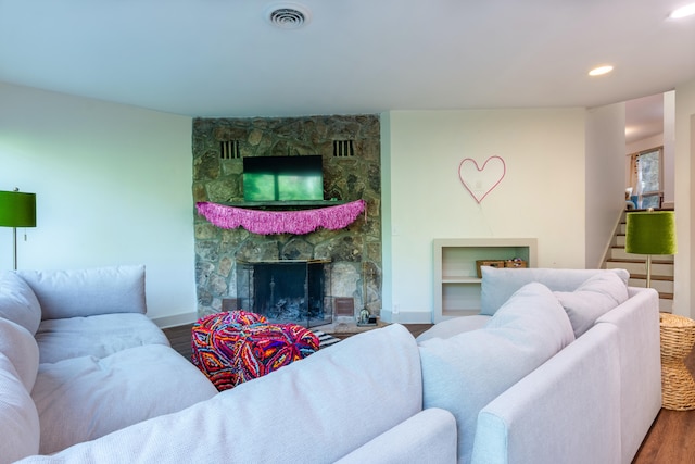 living room with hardwood / wood-style floors and a fireplace