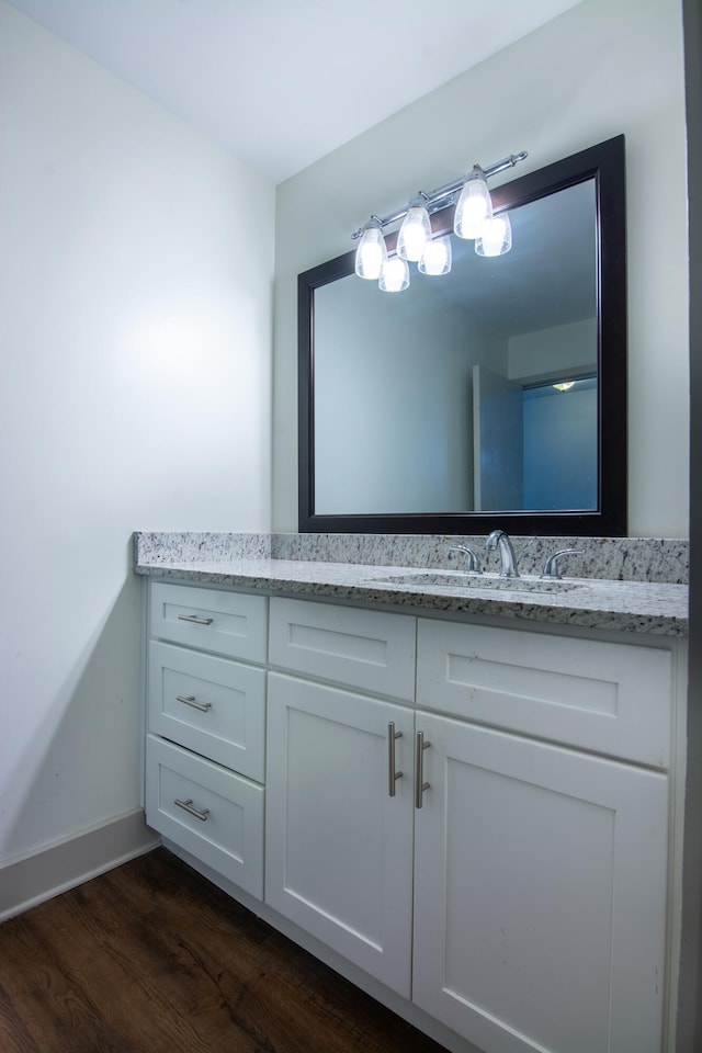 bathroom with vanity and hardwood / wood-style floors