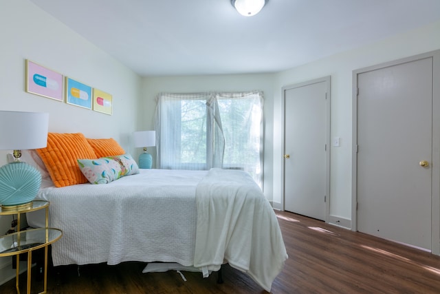 bedroom with dark hardwood / wood-style floors