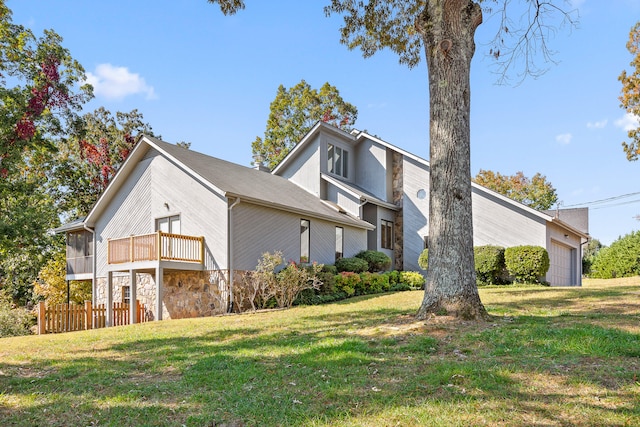 view of side of home with a yard and a garage