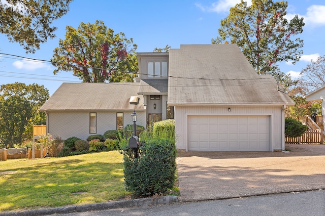 view of front of house featuring a front yard and a garage