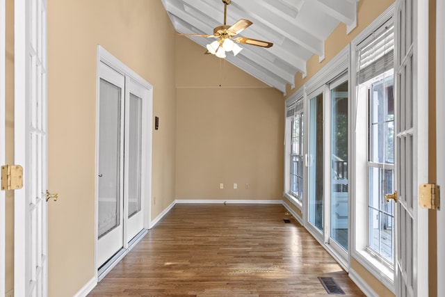 empty room featuring ceiling fan, hardwood / wood-style flooring, high vaulted ceiling, beamed ceiling, and french doors