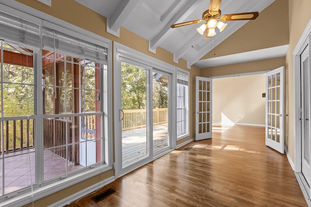 doorway with ceiling fan, hardwood / wood-style flooring, high vaulted ceiling, beamed ceiling, and french doors