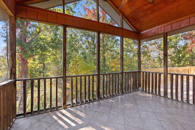 unfurnished sunroom with vaulted ceiling, a healthy amount of sunlight, and wooden ceiling