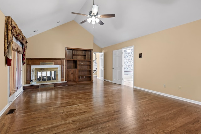 unfurnished living room with ceiling fan, high vaulted ceiling, and dark hardwood / wood-style floors