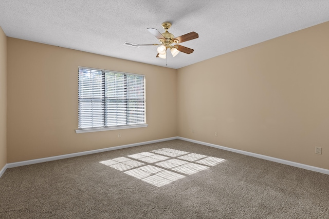 carpeted empty room with a textured ceiling and ceiling fan