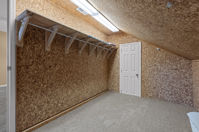 interior space with lofted ceiling and carpet