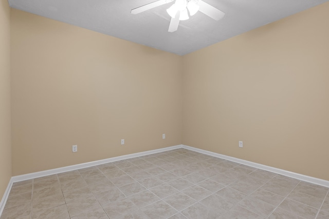 tiled spare room featuring ceiling fan