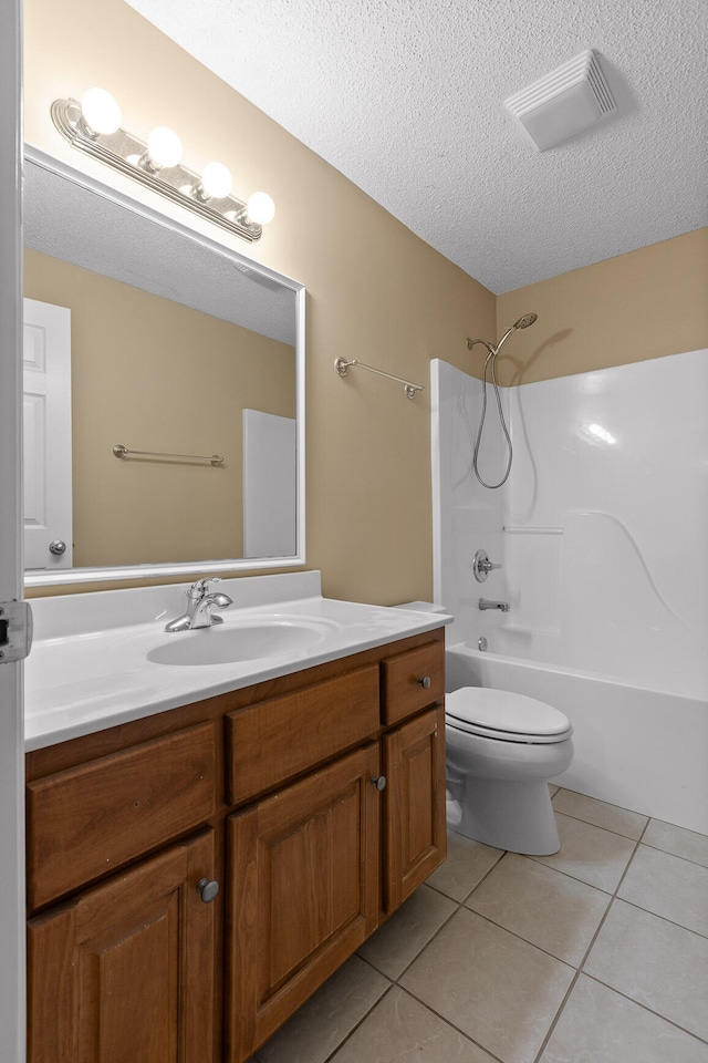 full bathroom with tile patterned floors, toilet, shower / bathtub combination, vanity, and a textured ceiling