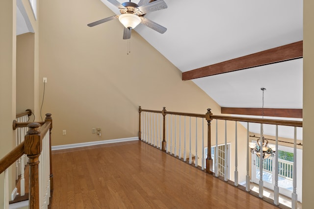 interior space featuring hardwood / wood-style floors, a chandelier, beam ceiling, and high vaulted ceiling