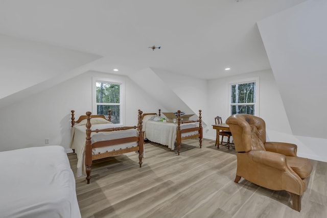 bedroom featuring lofted ceiling and light wood-type flooring