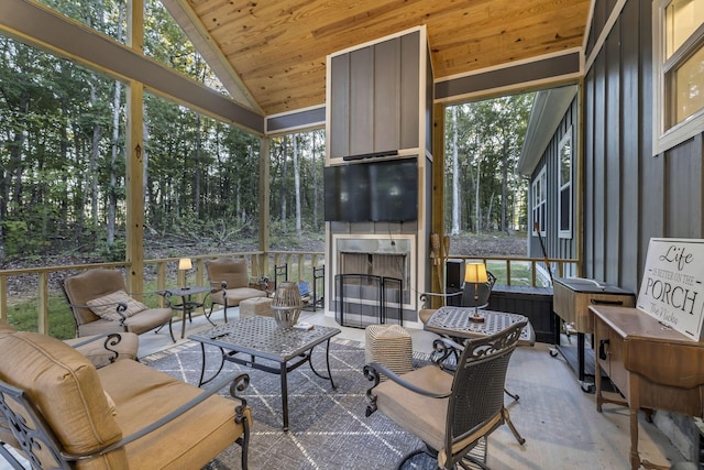 sunroom with wood ceiling and lofted ceiling