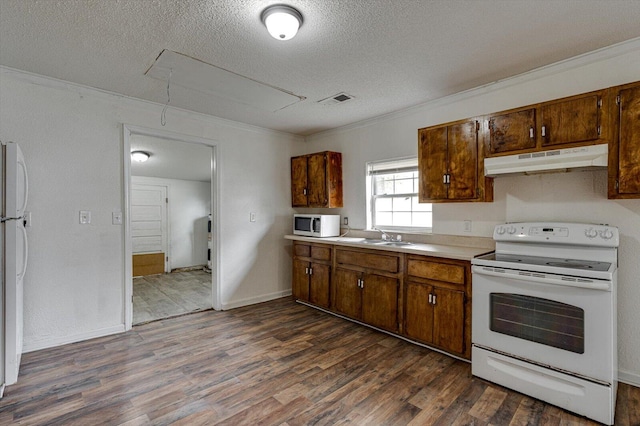 kitchen with crown molding, a textured ceiling, white appliances, and dark hardwood / wood-style flooring