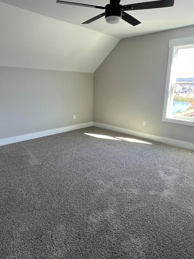 additional living space featuring lofted ceiling, carpet floors, and ceiling fan