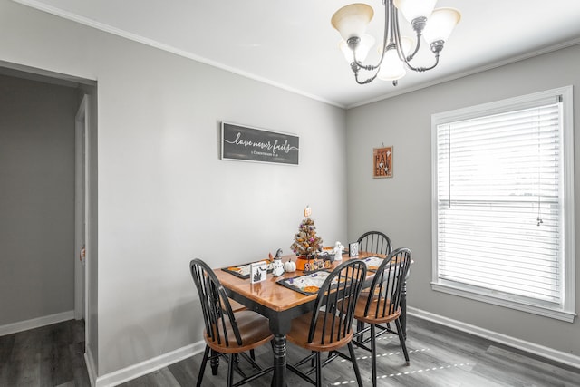 dining area featuring an inviting chandelier, crown molding, and dark hardwood / wood-style flooring