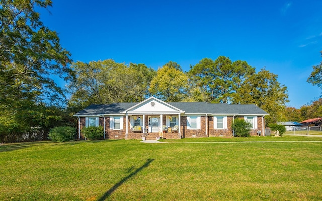 ranch-style home with covered porch and a front lawn