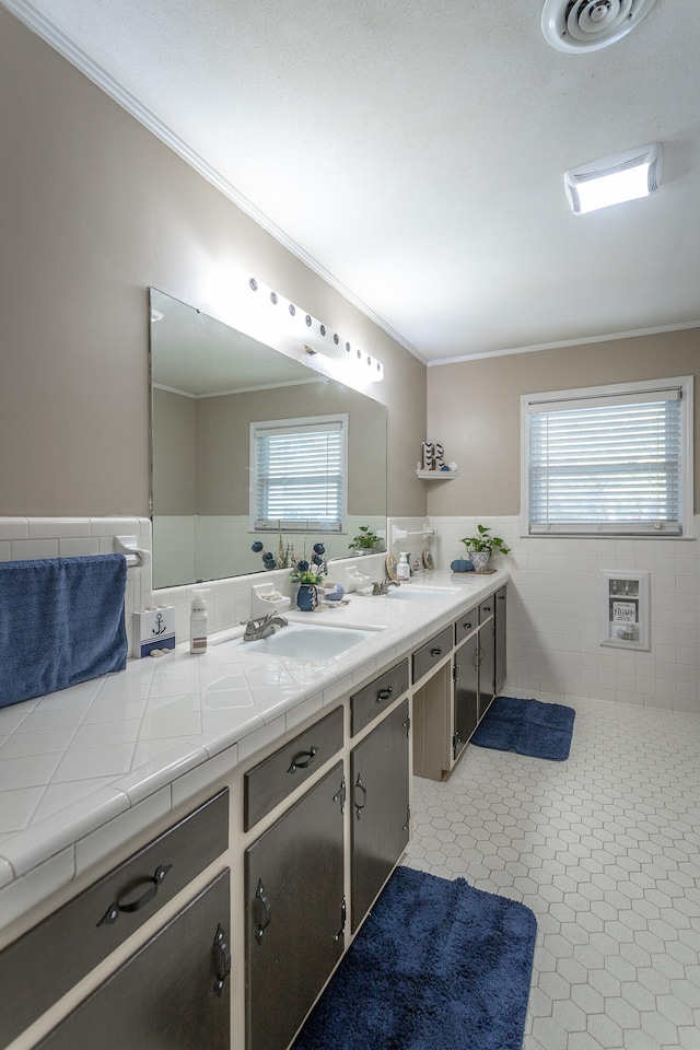 bathroom with heating unit, tile walls, ornamental molding, vanity, and tile patterned flooring