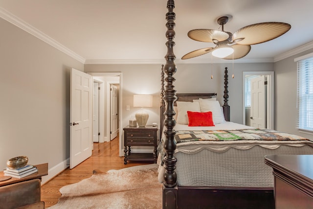 bedroom with light hardwood / wood-style floors, crown molding, and ceiling fan