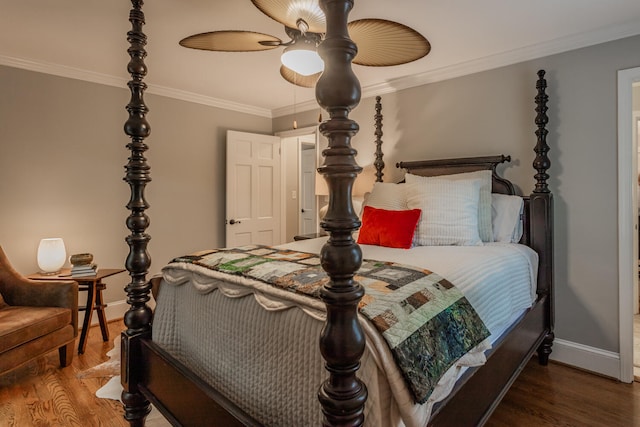 bedroom featuring ornamental molding, dark wood-type flooring, and ceiling fan