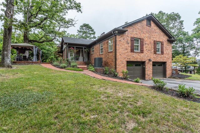 view of home's exterior featuring a yard, central AC, and a garage