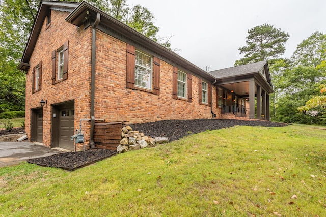 view of side of home featuring a yard and a garage