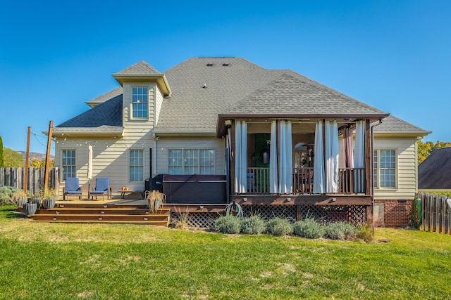 rear view of property featuring a deck and a lawn