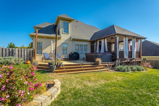 rear view of property with a lawn and a deck