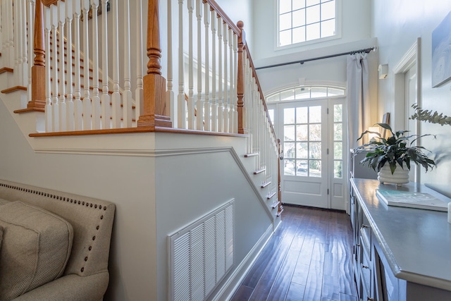 doorway with dark hardwood / wood-style flooring and plenty of natural light