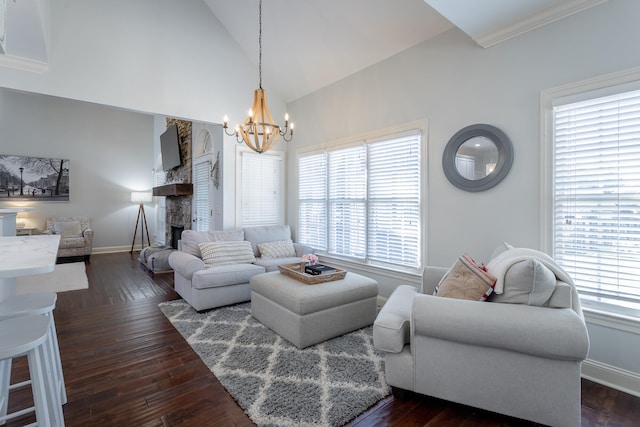 living room featuring dark hardwood / wood-style flooring, high vaulted ceiling, a notable chandelier, and plenty of natural light