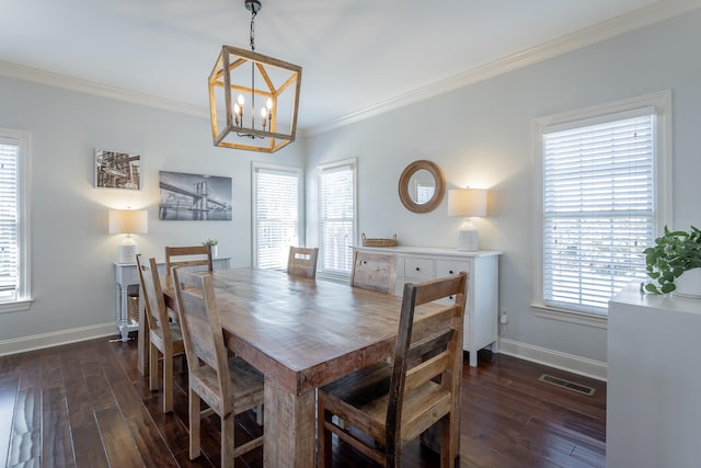 dining space featuring ornamental molding, plenty of natural light, and dark hardwood / wood-style floors