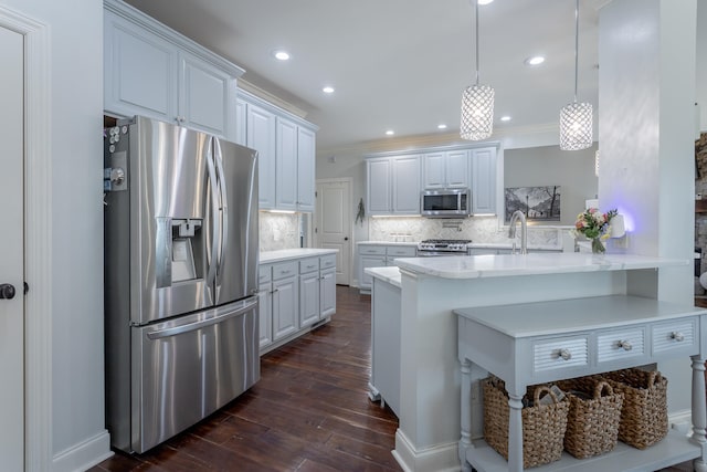 kitchen with tasteful backsplash, stainless steel appliances, white cabinetry, dark hardwood / wood-style floors, and pendant lighting