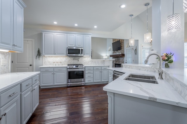 kitchen featuring stainless steel appliances, dark hardwood / wood-style flooring, sink, crown molding, and decorative light fixtures