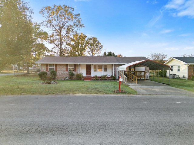 single story home featuring covered porch, a front lawn, and a carport