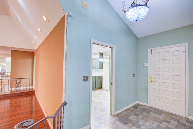 entryway featuring hardwood / wood-style flooring and high vaulted ceiling