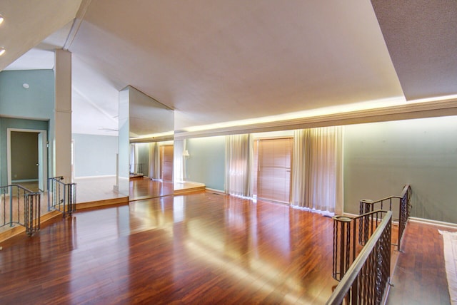 unfurnished room featuring high vaulted ceiling and hardwood / wood-style floors