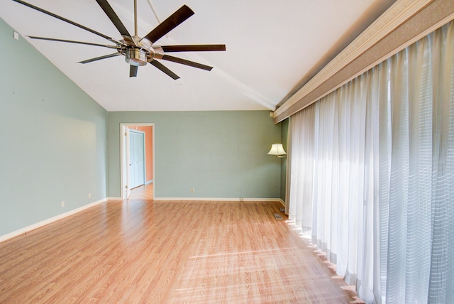 spare room with light hardwood / wood-style flooring, lofted ceiling, and ceiling fan