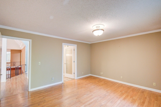 unfurnished room featuring light hardwood / wood-style flooring, a textured ceiling, and crown molding