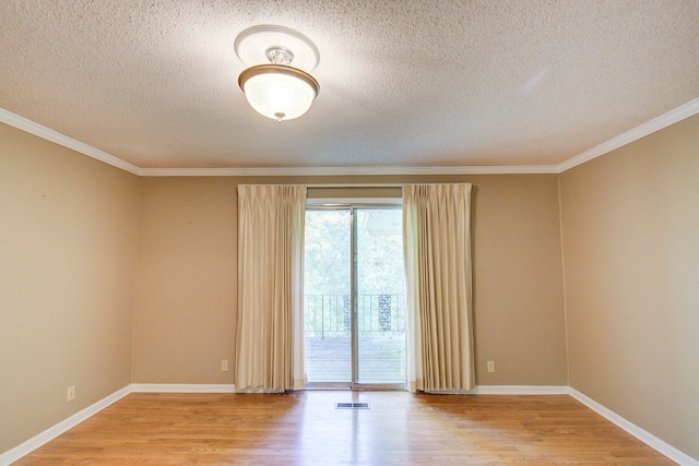 spare room featuring crown molding, a textured ceiling, and light wood-type flooring