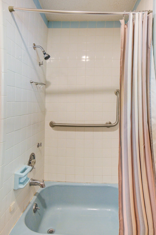 bathroom featuring shower / bathtub combination with curtain