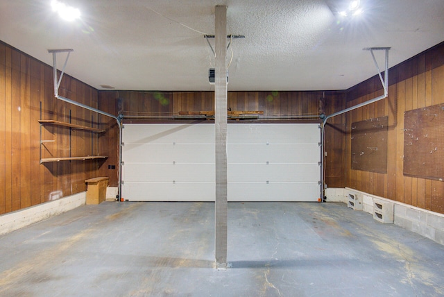 garage featuring wood walls