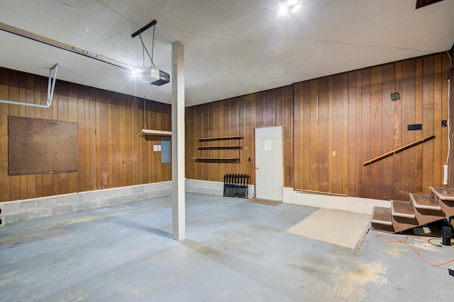 garage with wooden walls and a garage door opener