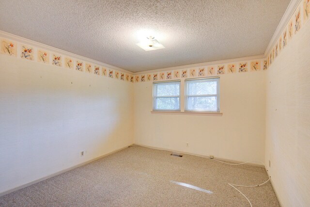 carpeted spare room featuring crown molding and a textured ceiling