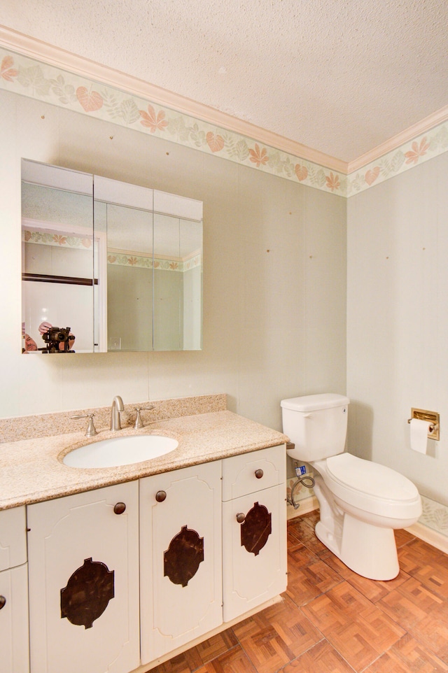 bathroom featuring vanity, toilet, a textured ceiling, and parquet floors