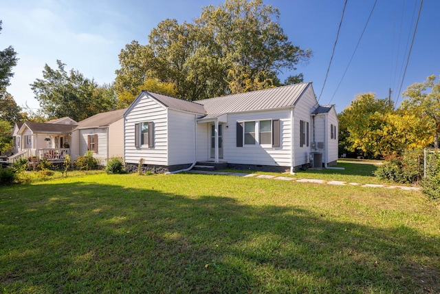 view of front of house with a front yard and central AC unit