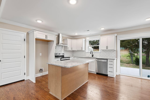 kitchen featuring a center island, white cabinets, wall chimney range hood, and appliances with stainless steel finishes